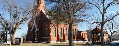 A duplicate red brick church sits in the middle of a snowy field in Marysville.
