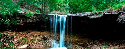 A Marysville waterfall nestled in a wooded area.