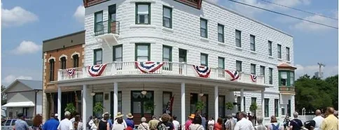 A group of people standing in front of a Waterville building.