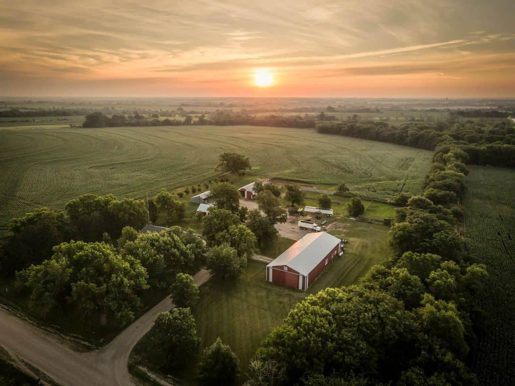 An aerial view of a farm at sunset.